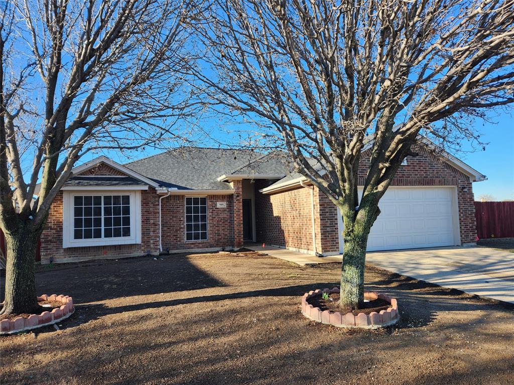 a view of a house with a fire pit and a tree