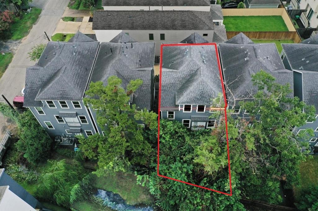 an aerial view of a house with a yard and garden