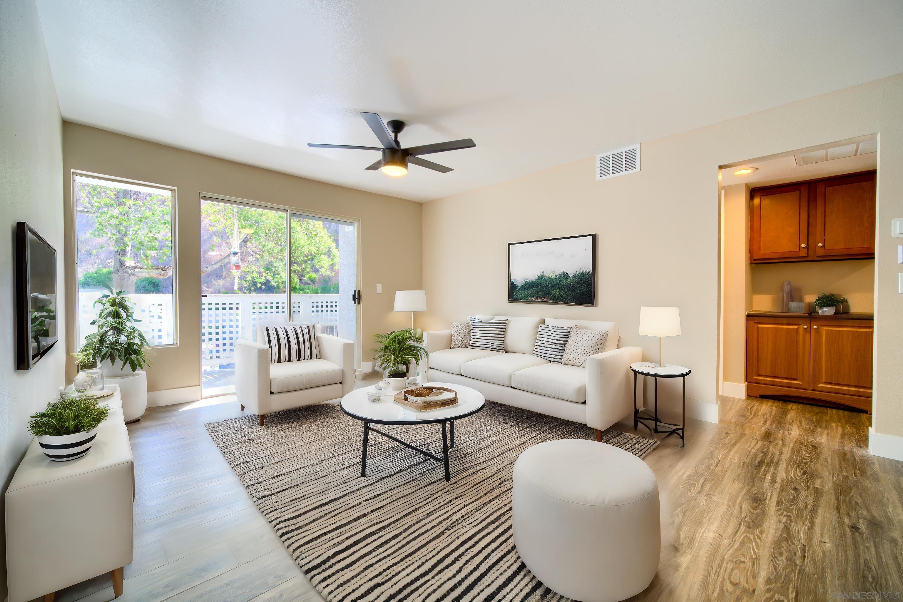 a living room with furniture and a large window