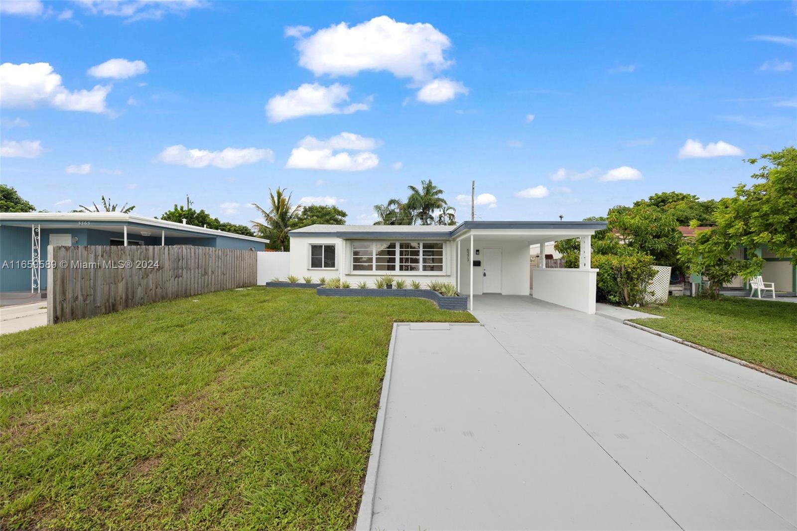 a view of house with outdoor space and sitting area