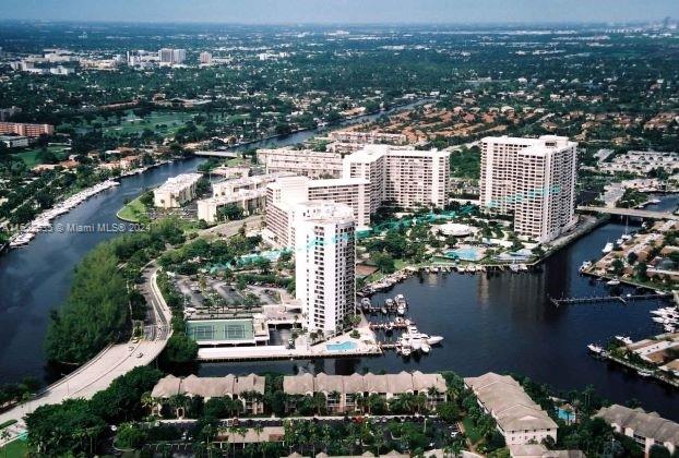 an aerial view of lake and residential houses with outdoor space