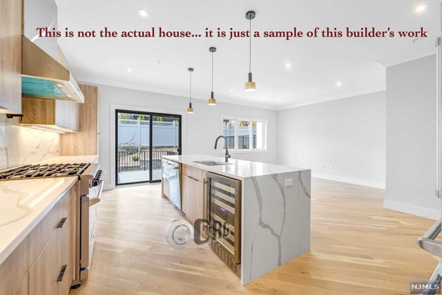 a large kitchen with stainless steel appliances granite countertop a stove and a sink