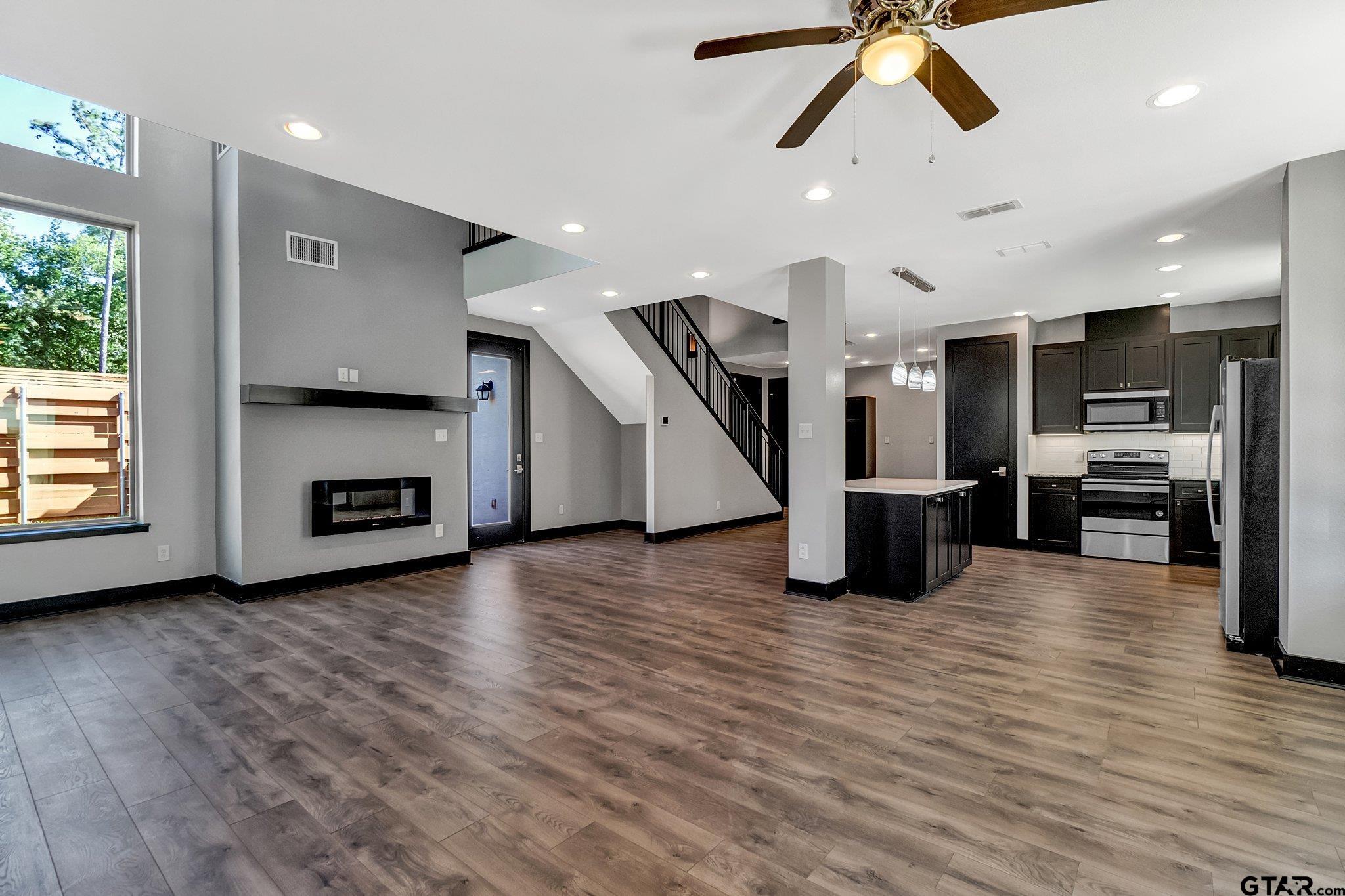 a view of a kitchen with furniture and a ceiling fan