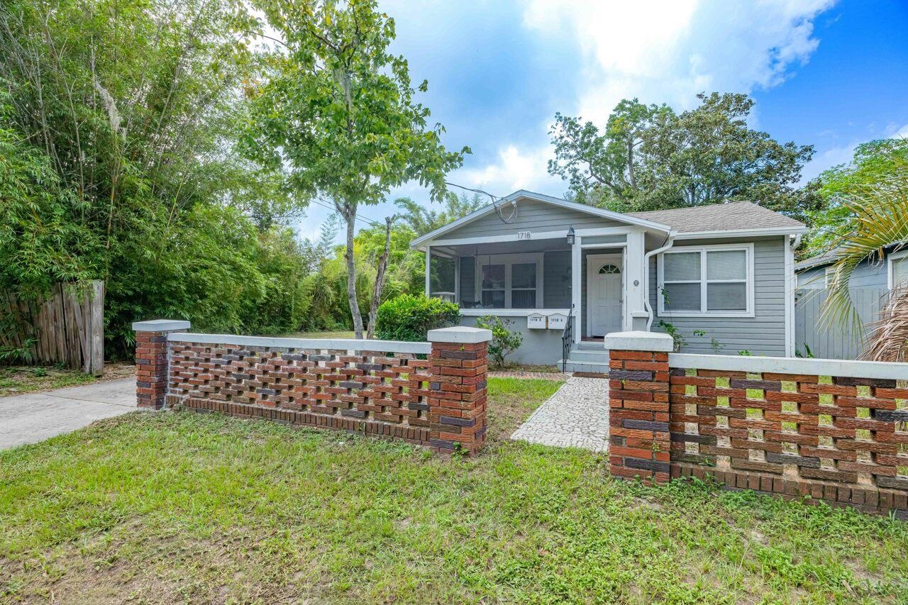 a view of a house with a yard and sitting area