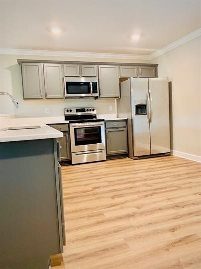 a kitchen with stainless steel appliances a refrigerator and a stove top oven