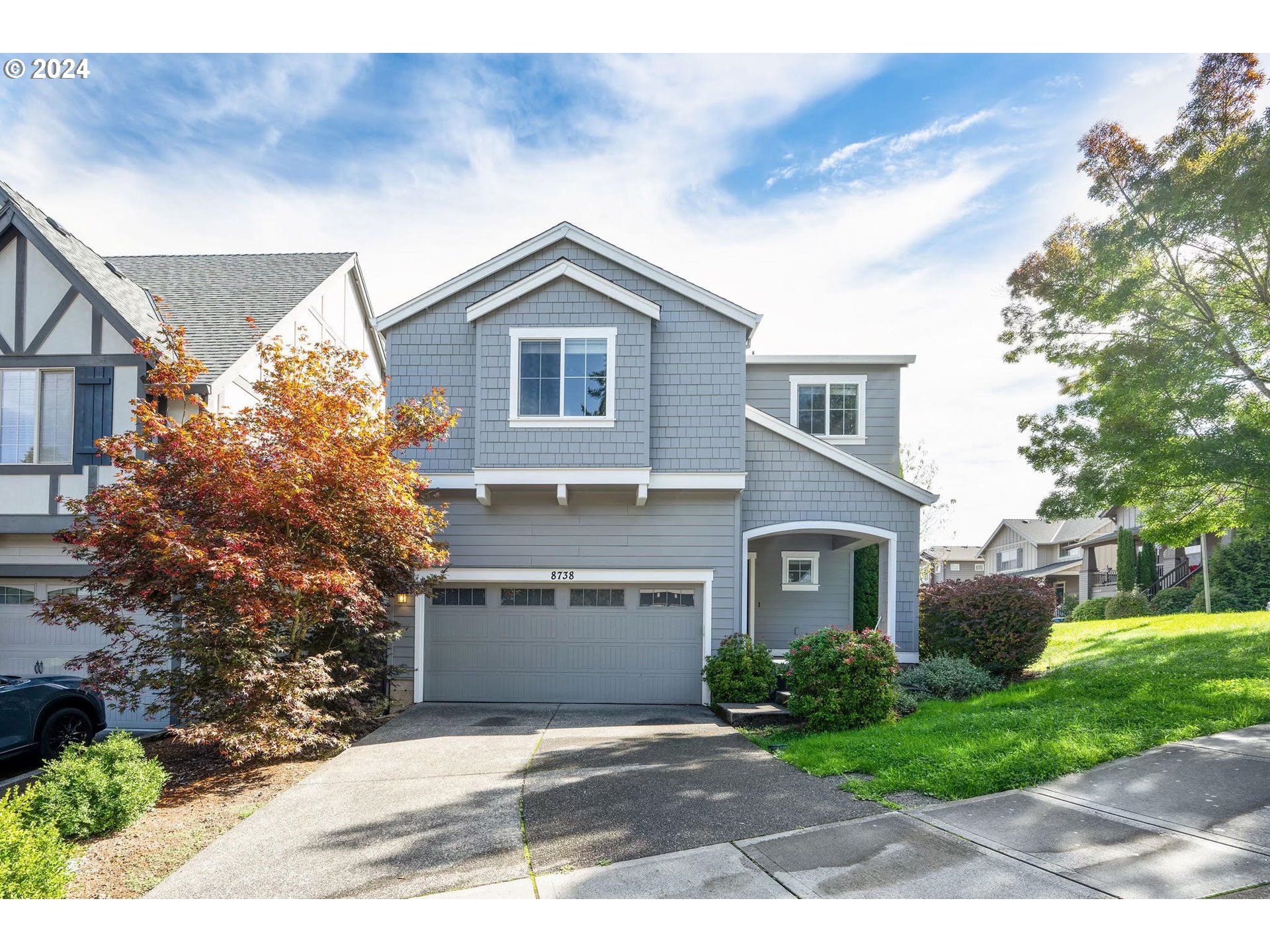 a front view of a house with a yard and garage