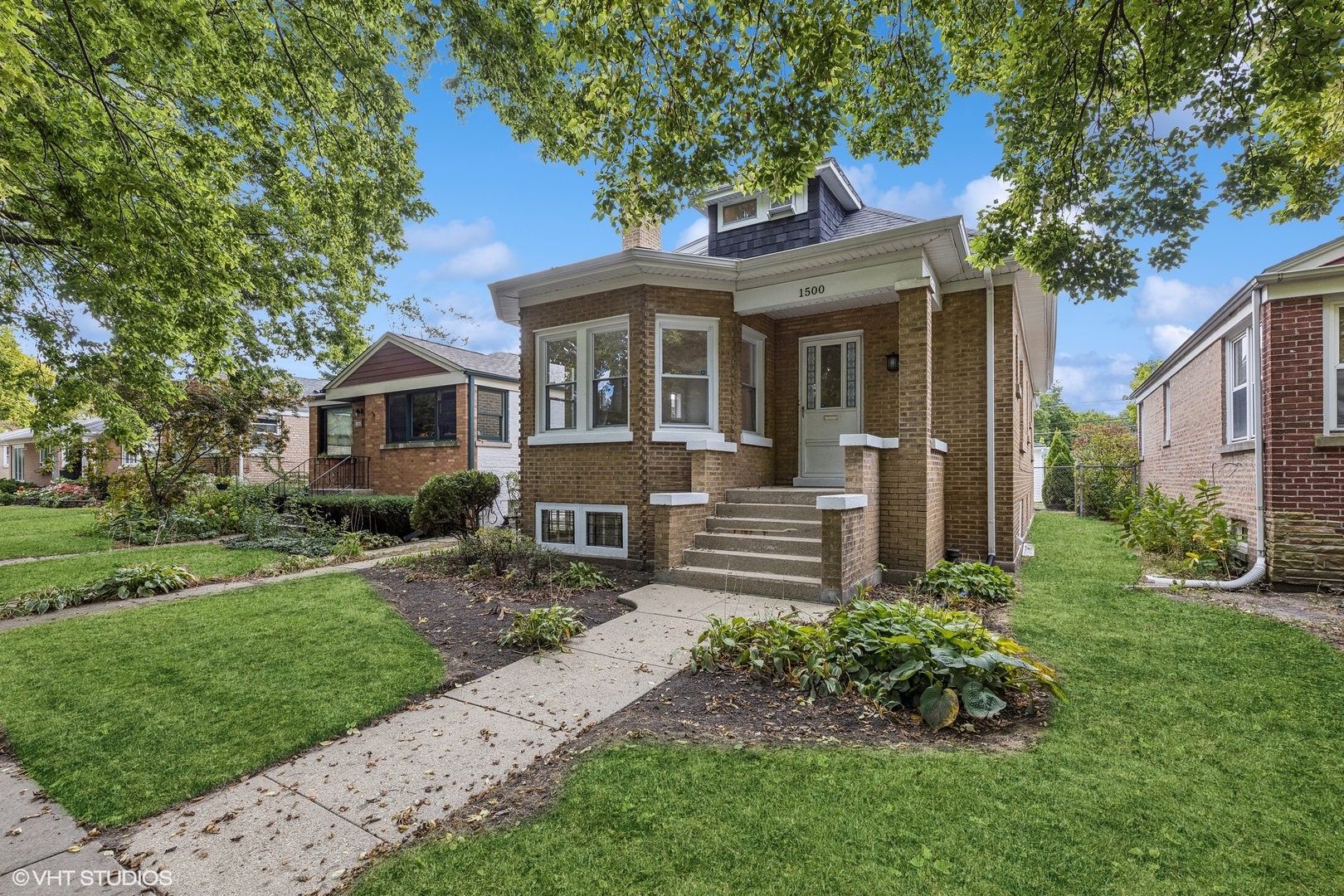 a front view of a house with a yard table and chairs