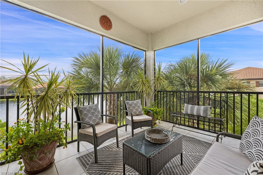 a view of a balcony with chairs and wooden floor