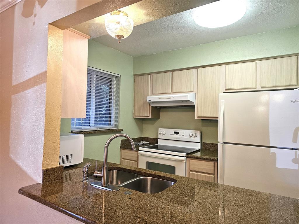 a kitchen with kitchen island a sink appliances and cabinets