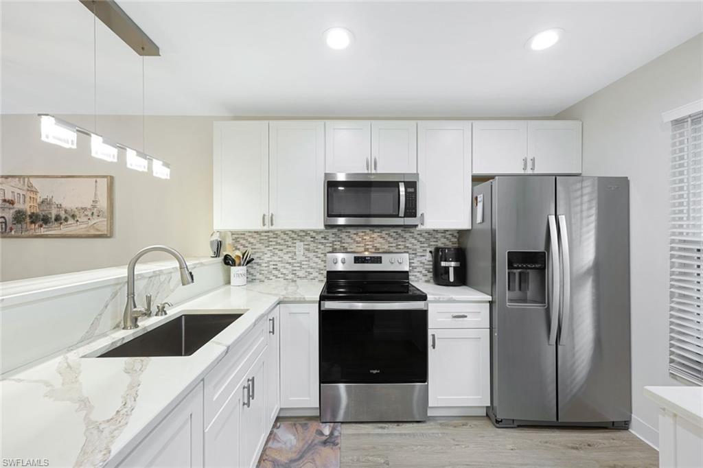 a kitchen with a sink cabinets and stainless steel appliances