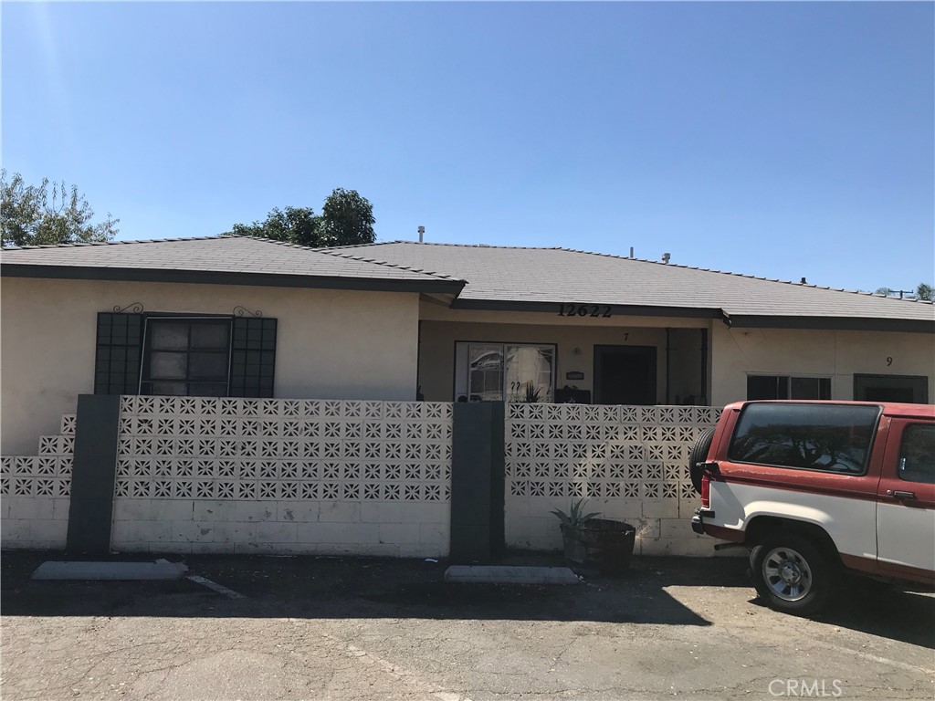 a front view of a house with parking space