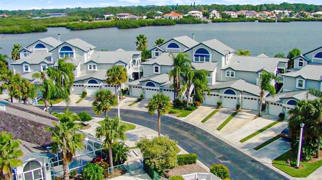 an aerial view of residential houses with outdoor space and river view