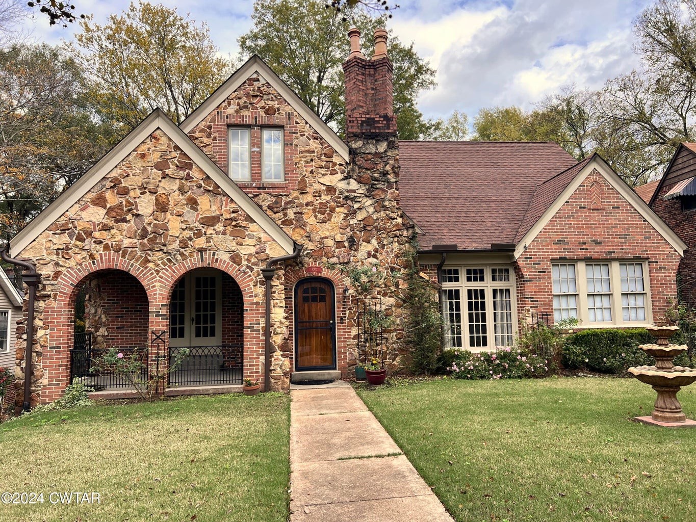 a front view of a house with garden