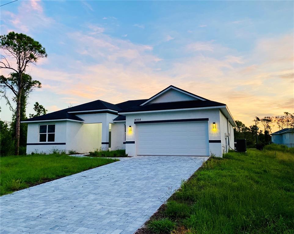 a front view of house with yard and green space