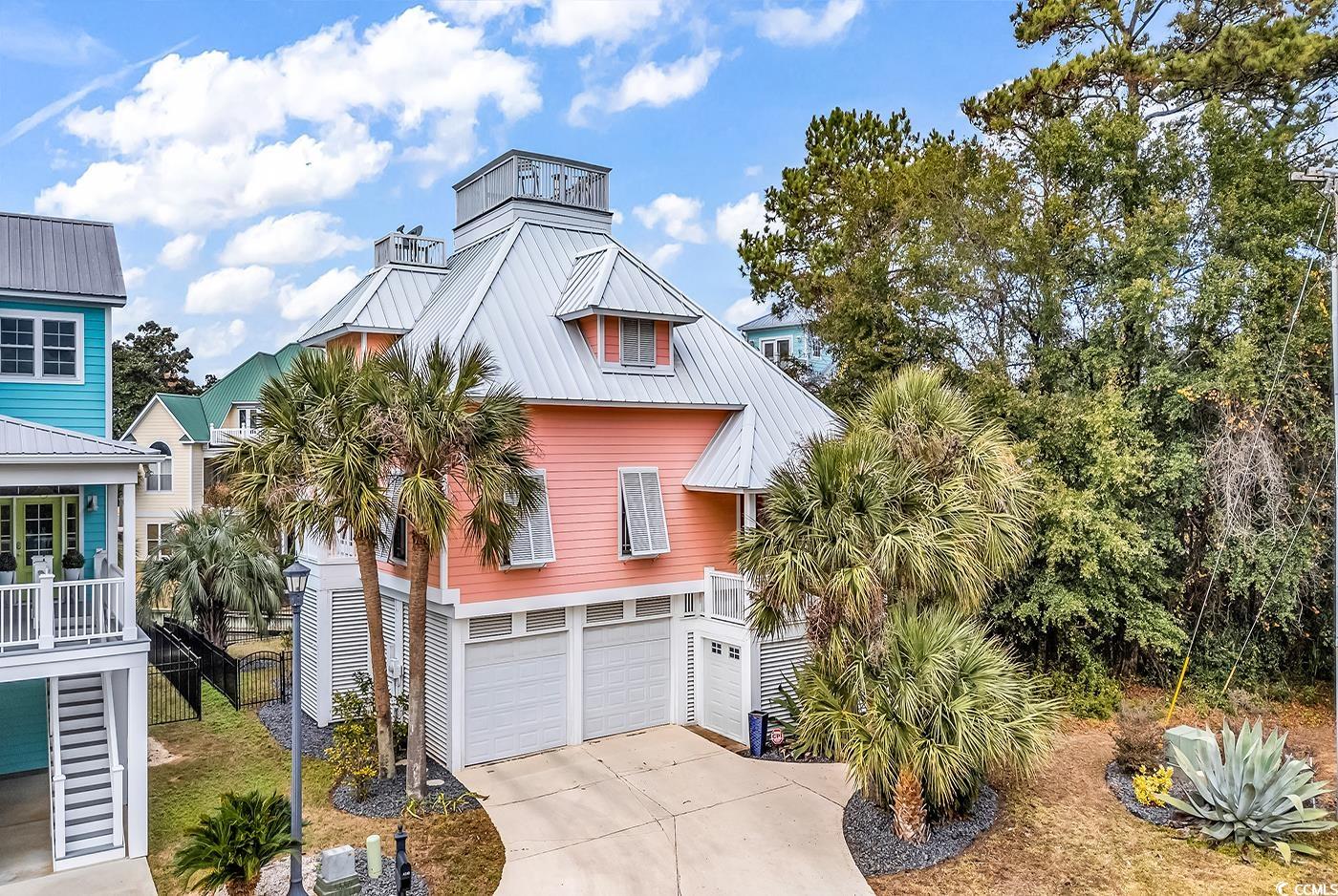 Raised beach house featuring a garage