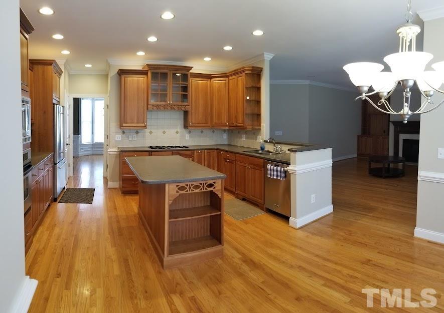 a kitchen with kitchen island a counter top space appliances and cabinets