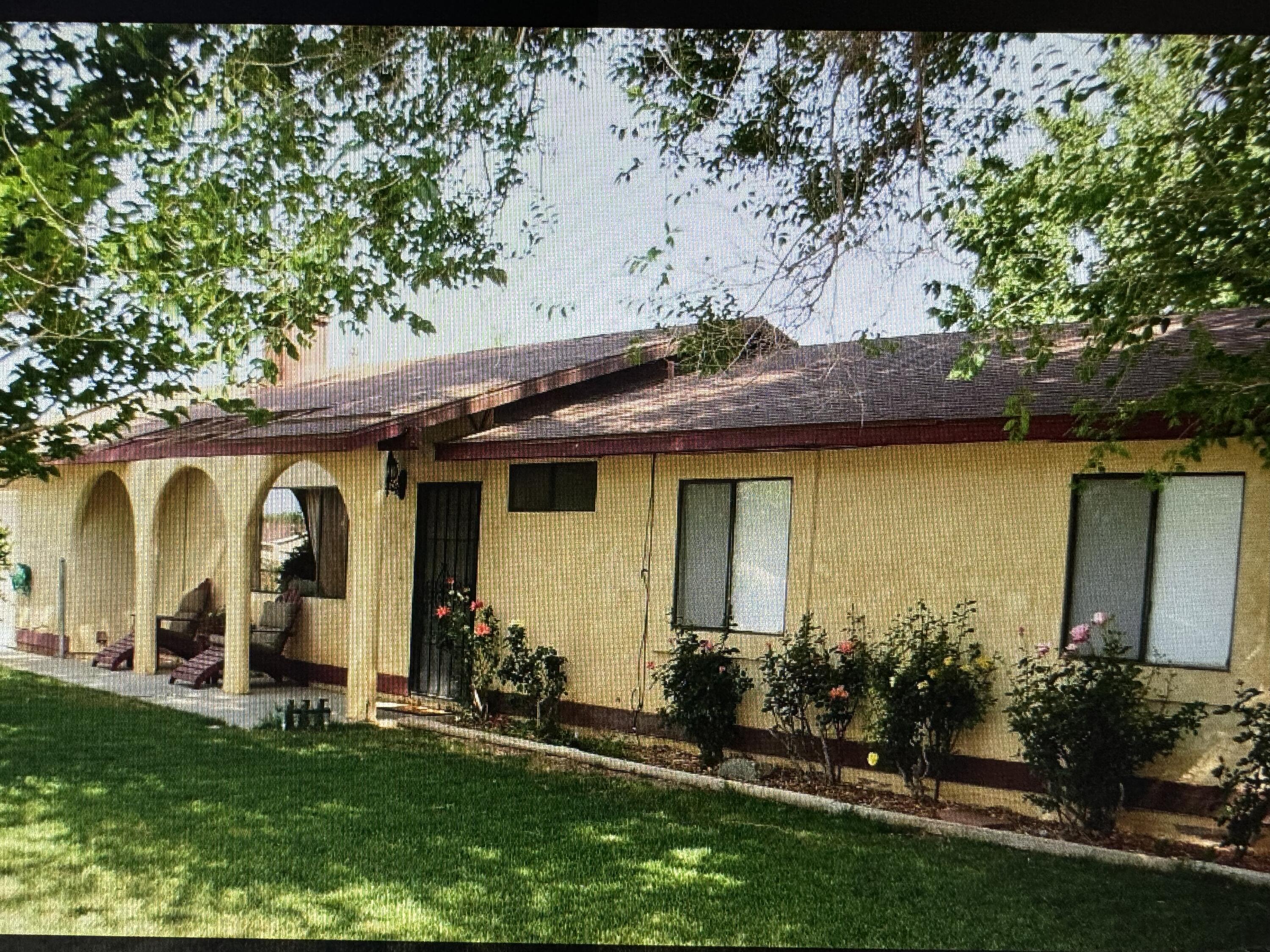 a view of a house with large windows and a yard