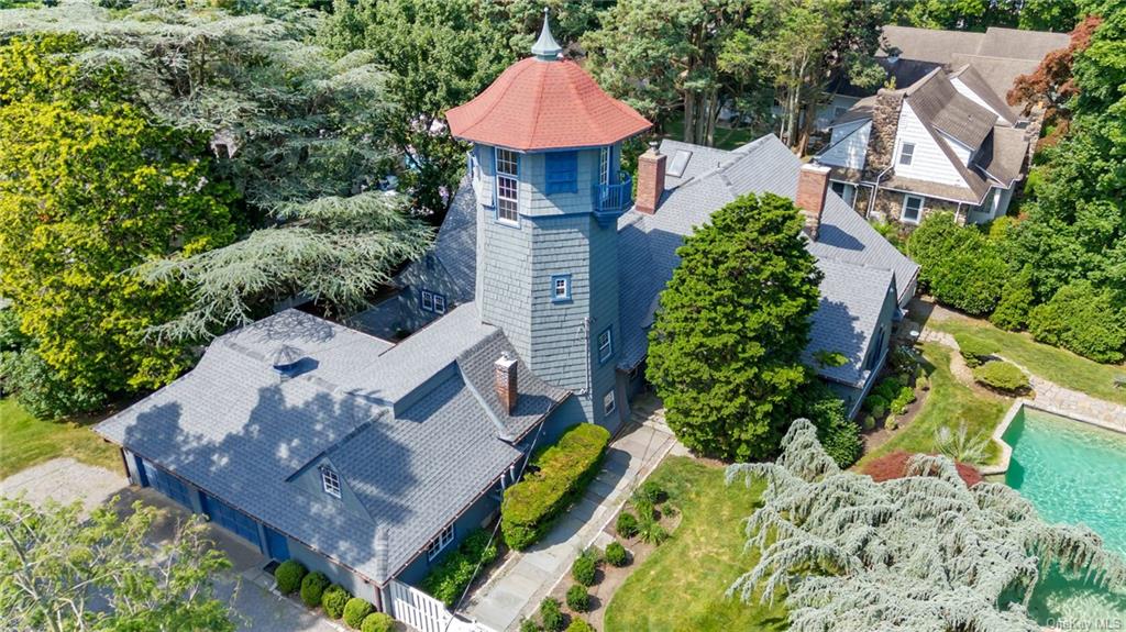 an aerial view of a house with a yard and garden