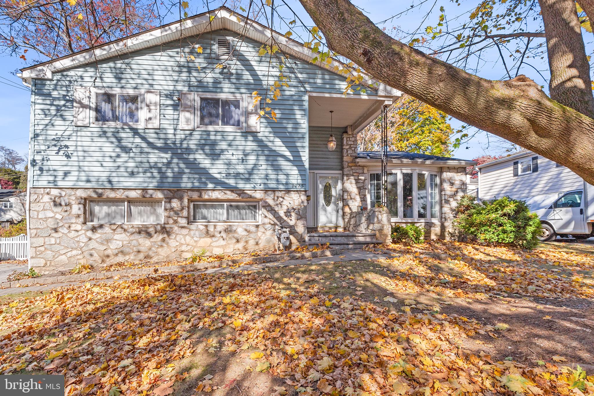 a brick building with a large tree in front of it