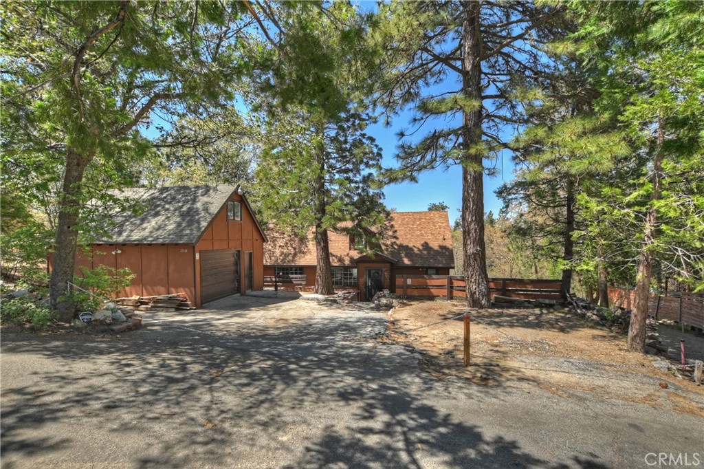 a view of a house with a tree in the yard