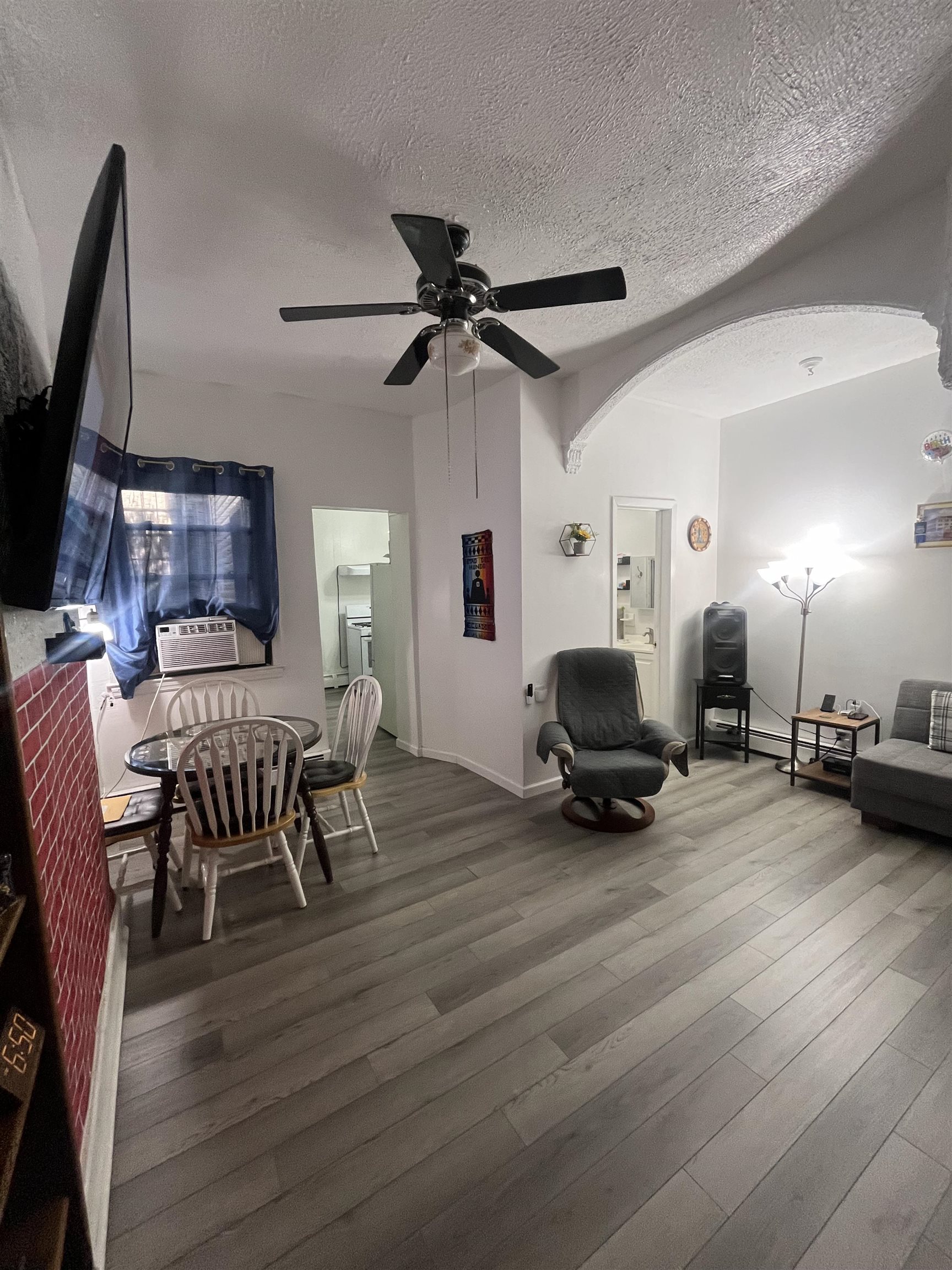 a living room with furniture a wooden floor and a fireplace