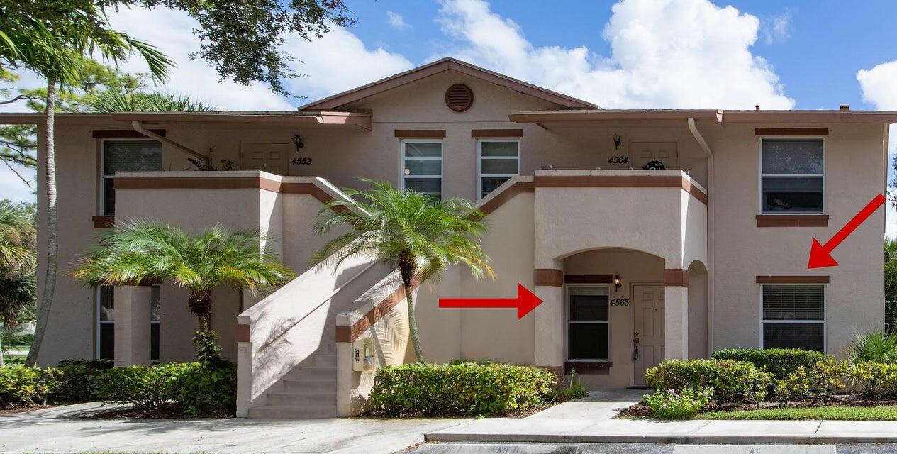 a front view of a house with plants