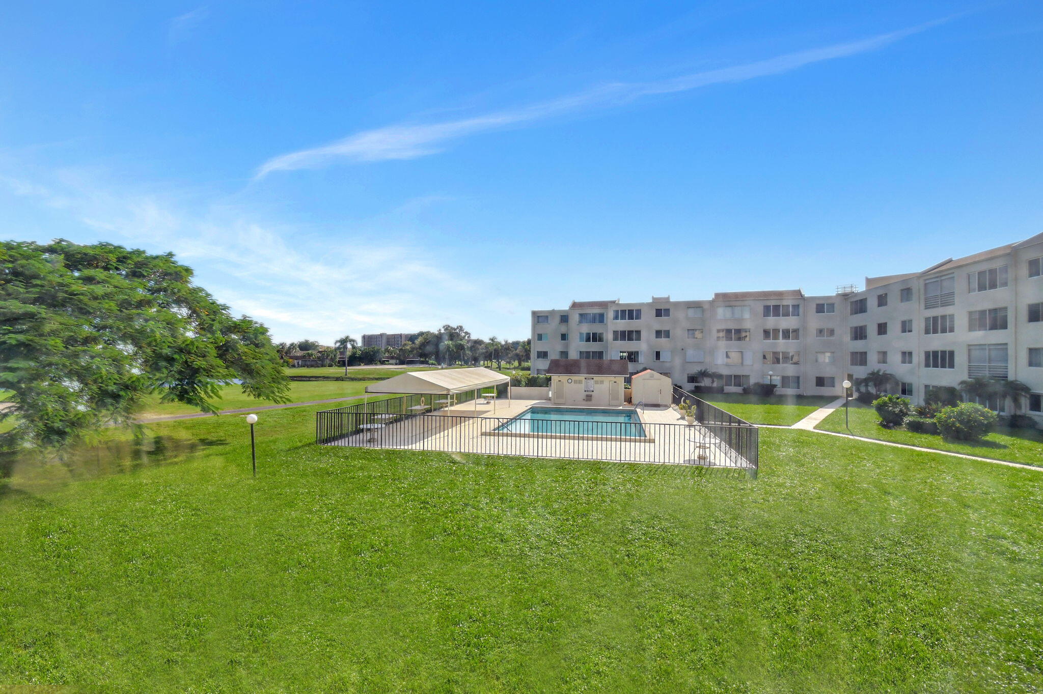 a view of a swimming pool with a yard