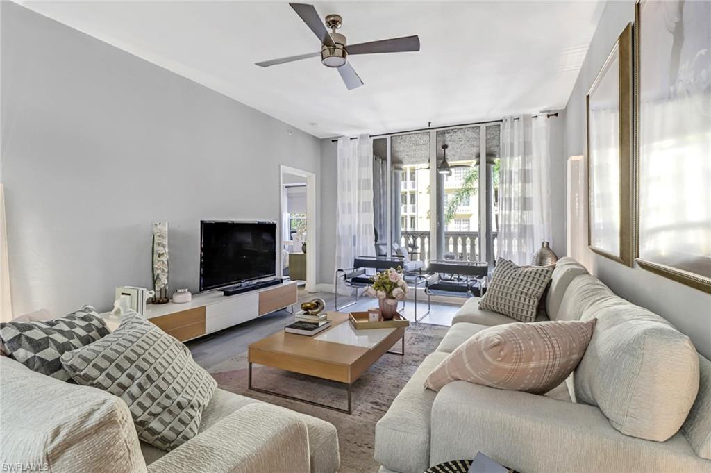 Living room featuring ceiling fan and hardwood / wood-style flooring