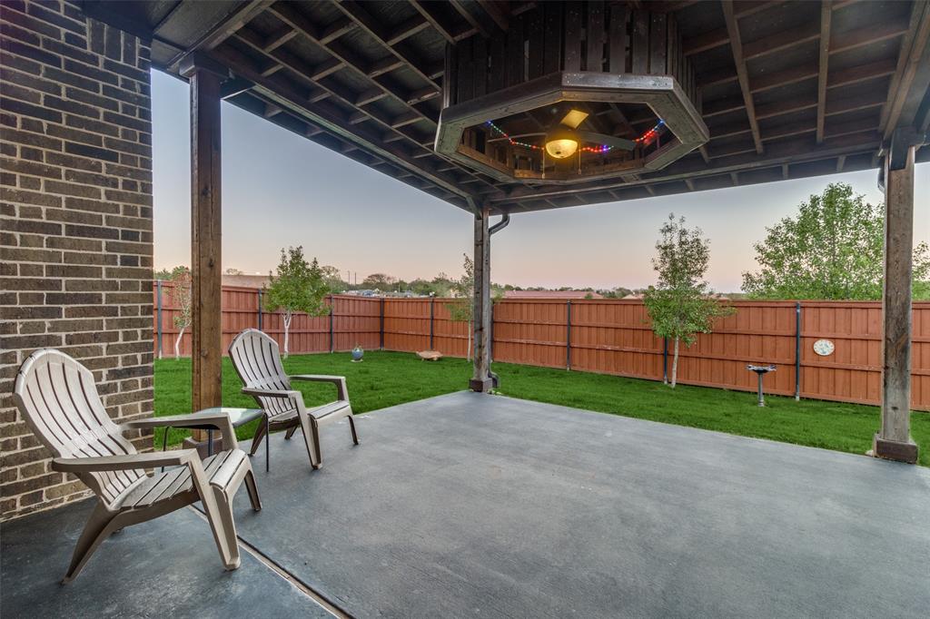 a view of a chair and table in the patio