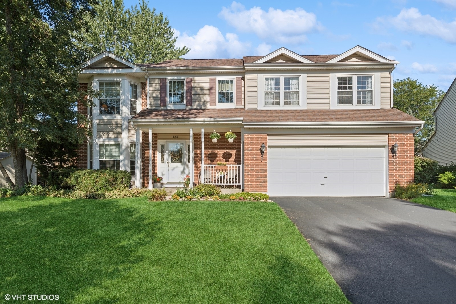 a front view of a house with a yard and garage