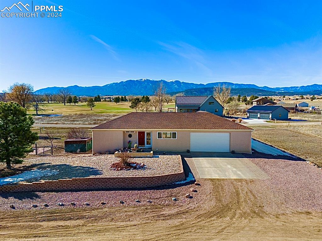 Ranch-style house featuring a mountain view and a garage