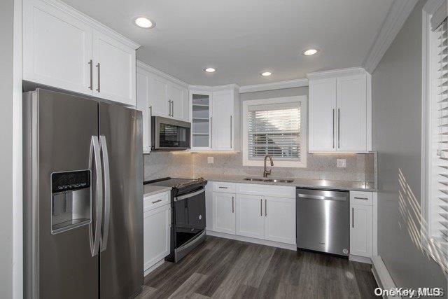 a kitchen with stainless steel appliances a refrigerator sink and microwave