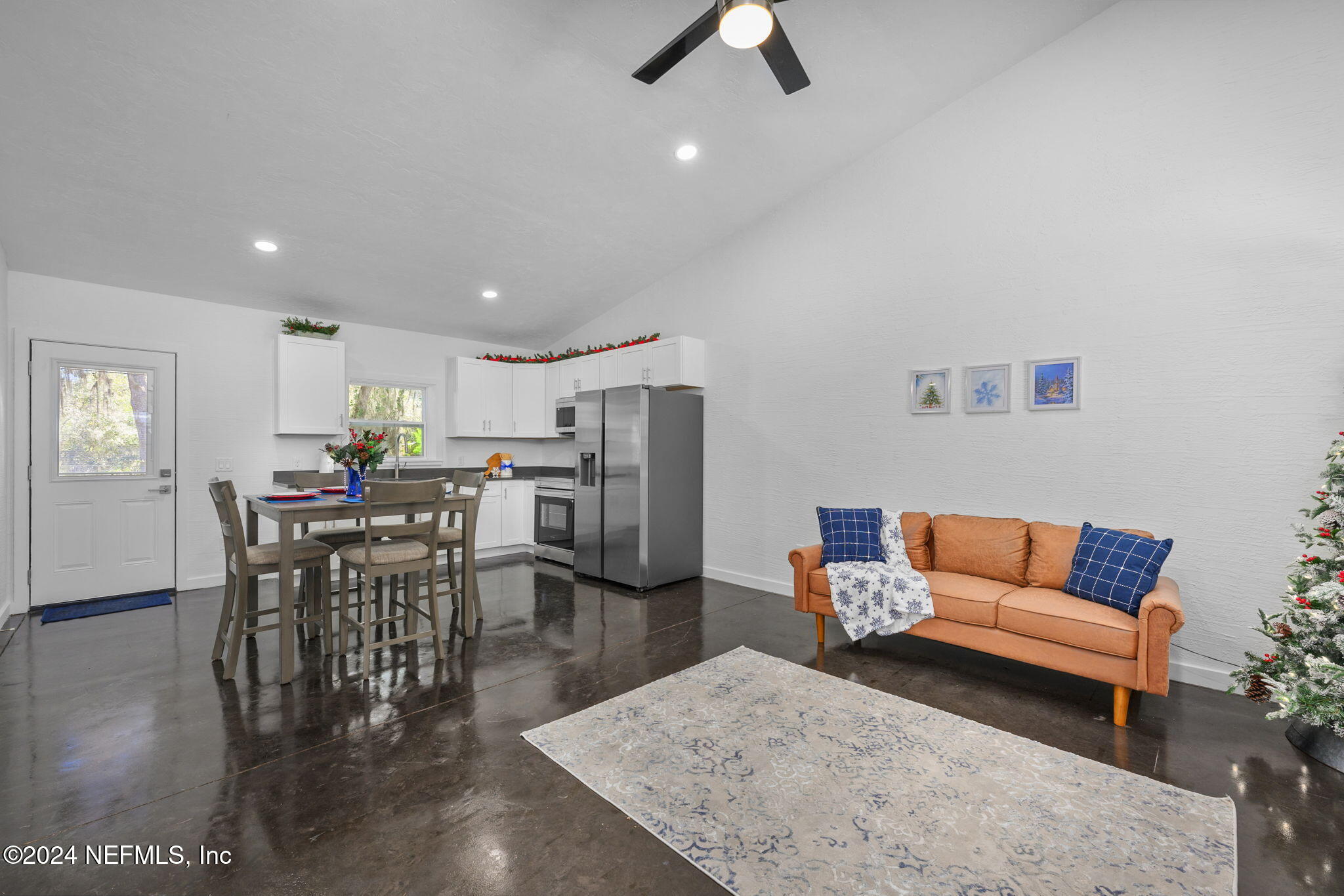 a living room with furniture kitchen view and a dining table