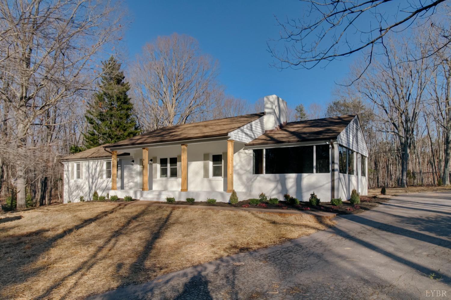 a view of a house with a yard covered in snow