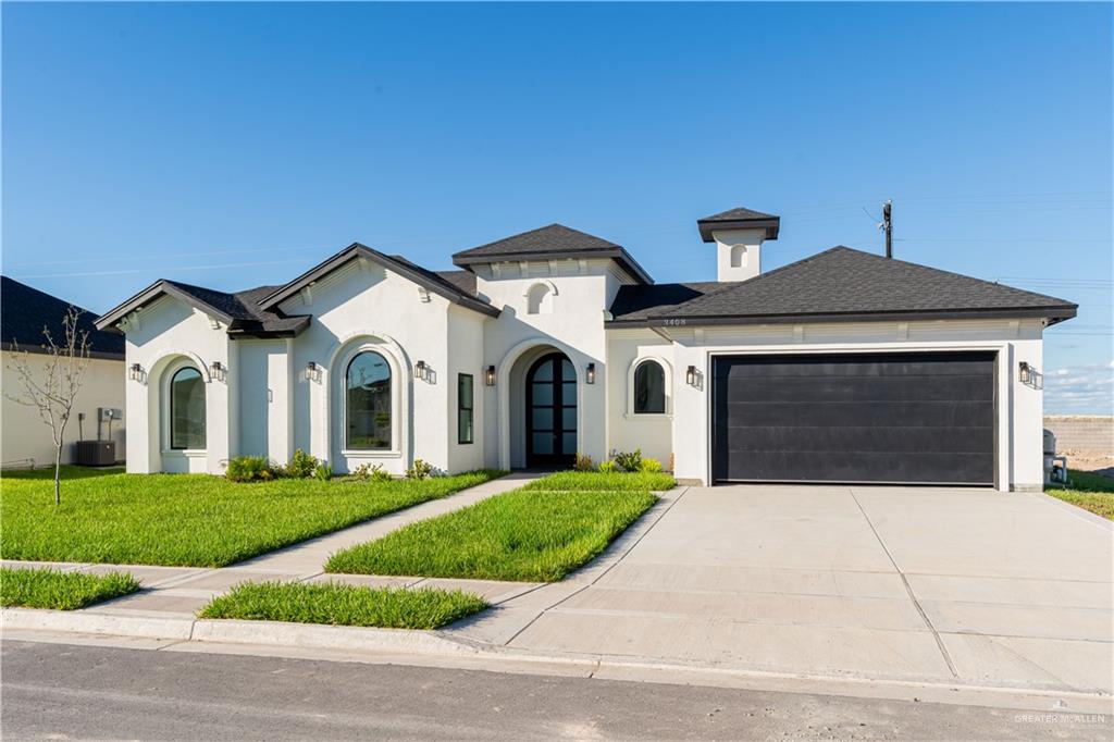 a front view of a house with a yard and garage