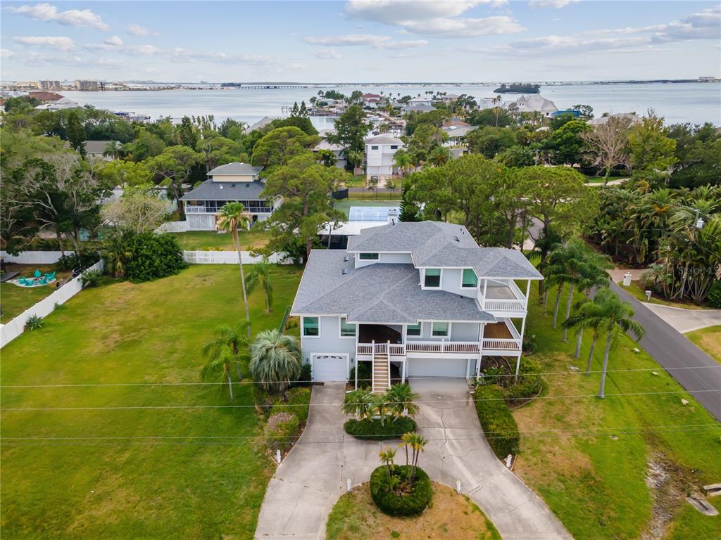 an aerial view of residential houses with outdoor space and trees