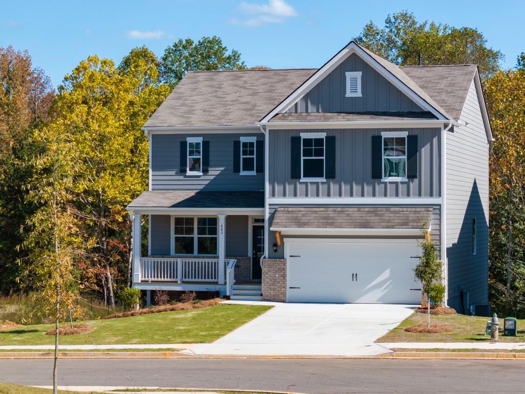 a front view of a house with a garden