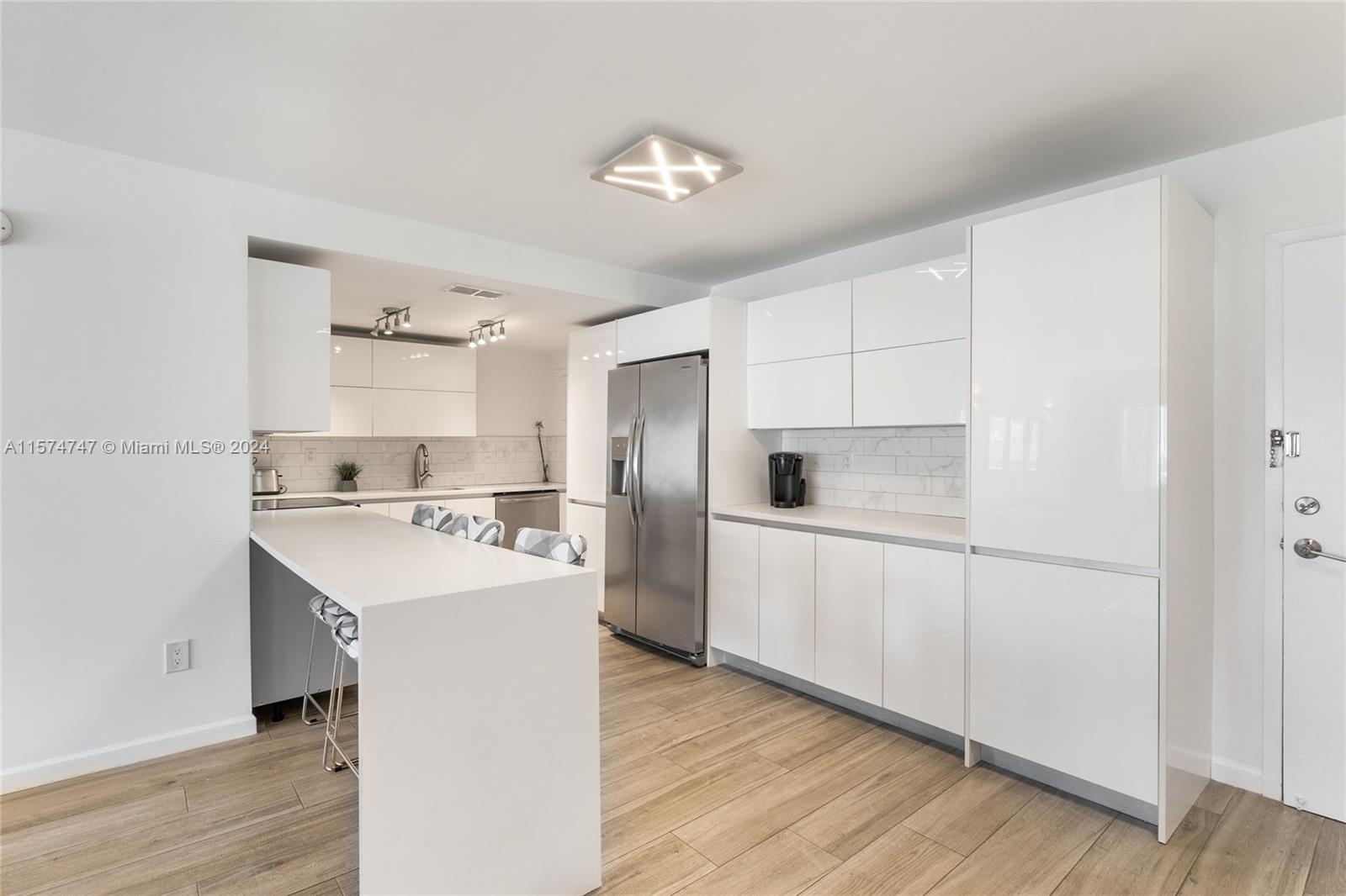 a kitchen with white cabinets and white appliances