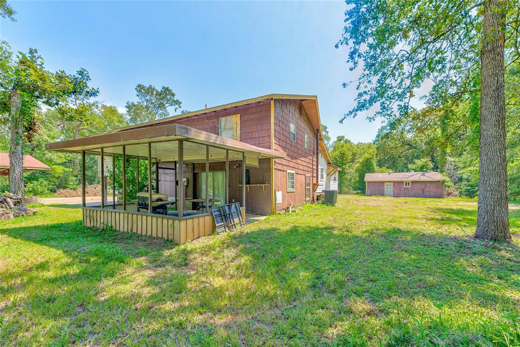 a view of a house with backyard and sitting area