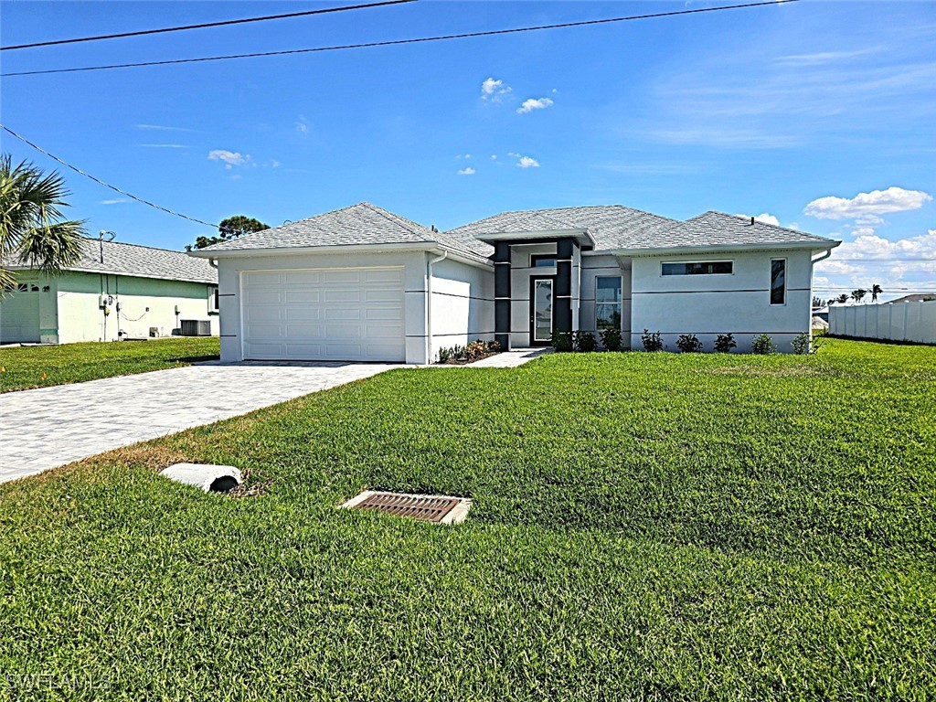 a front view of a house with a yard and garage