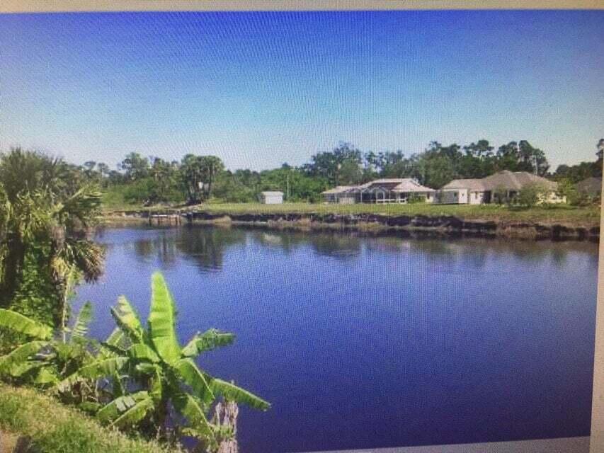 a view of a lake with houses in the back