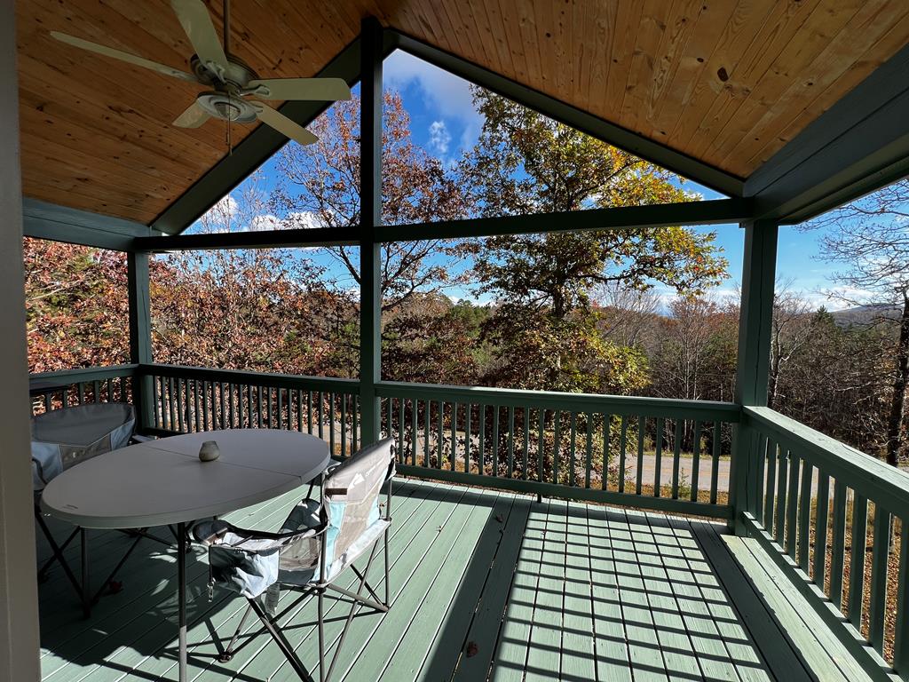 a view of a chairs and table in the balcony