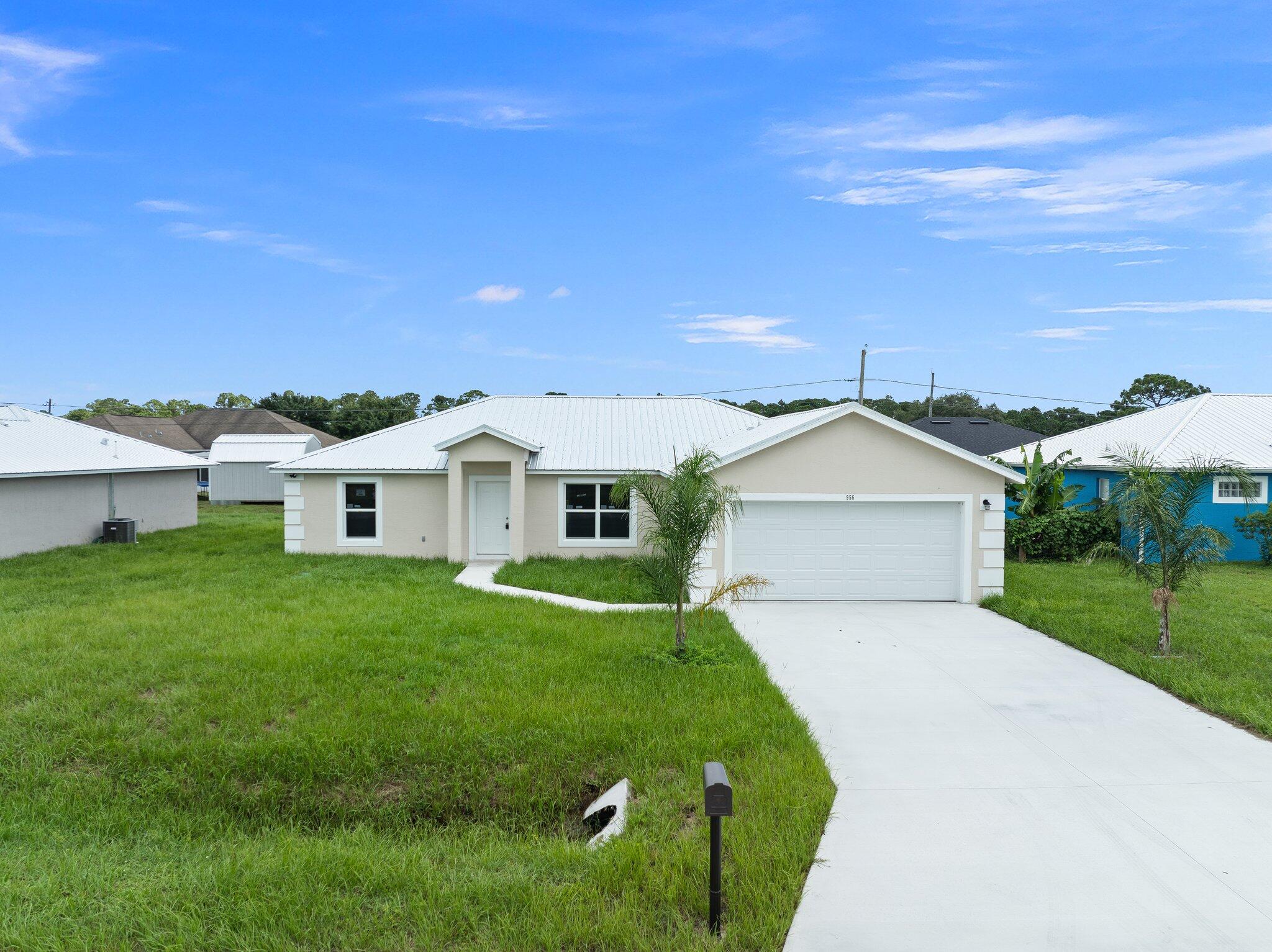 a front view of a house with a garden and yard