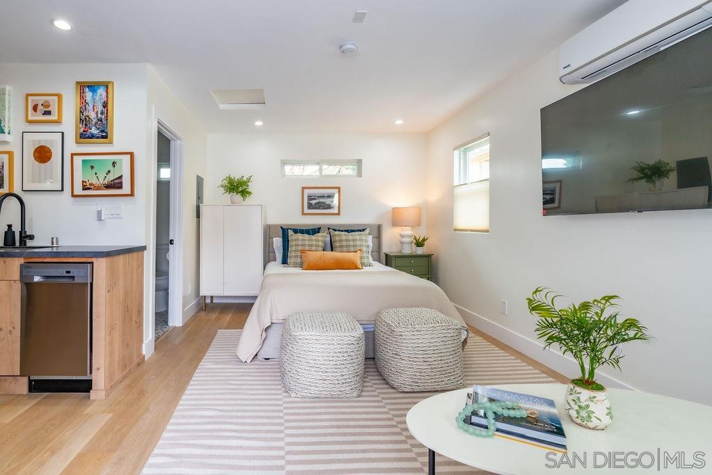 a bedroom with a bed and a potted plant