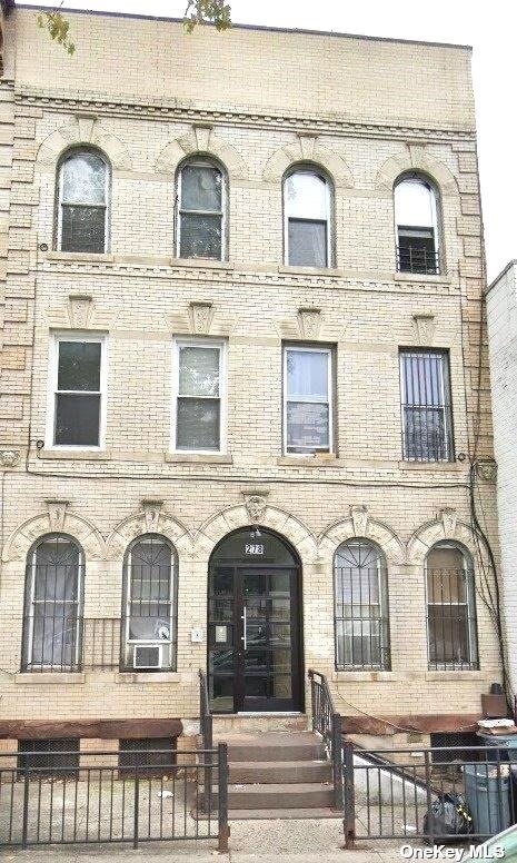 a view of a brick house with large windows