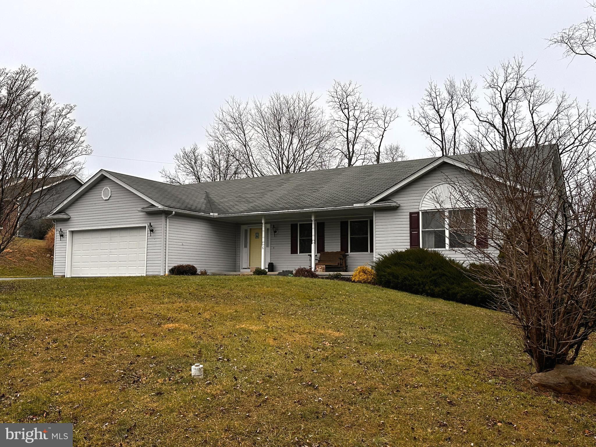 a front view of a house with a garden and yard