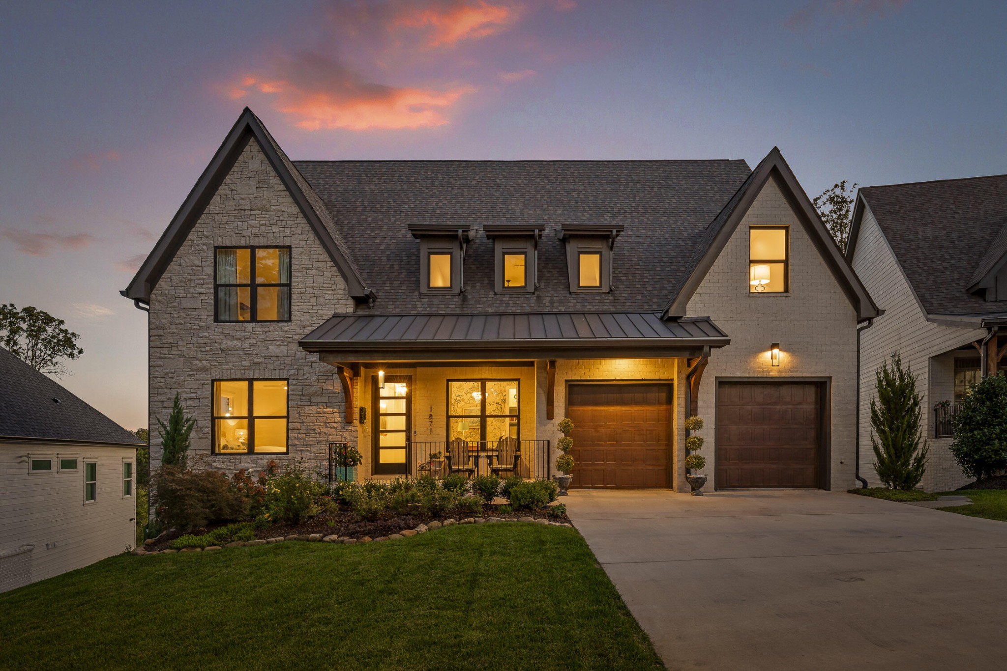 a front view of a house with a yard and garage