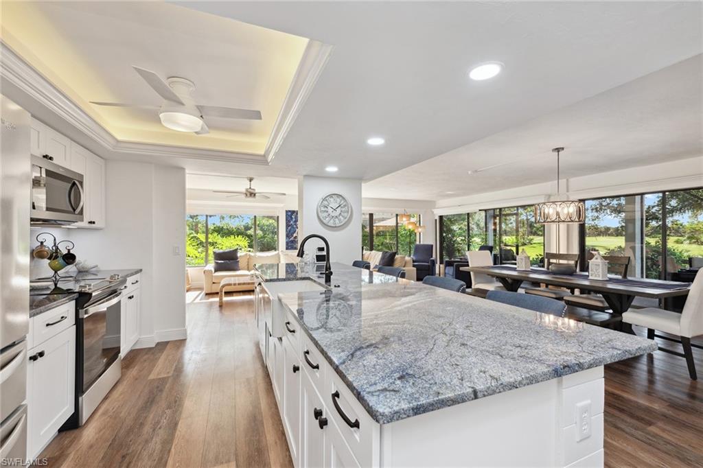 a kitchen with sink stove and view living room