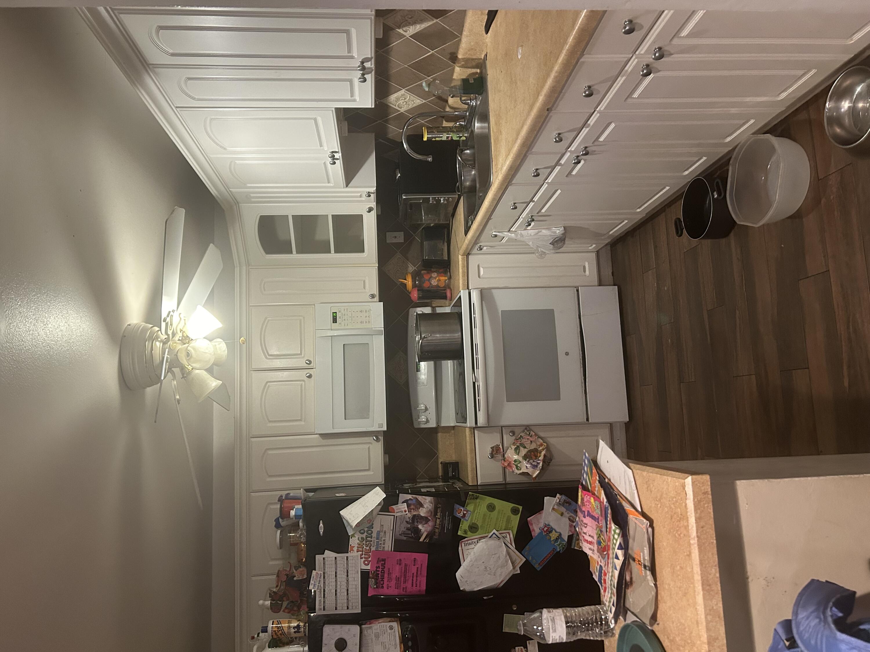 a kitchen with a sink cabinets and wooden floor