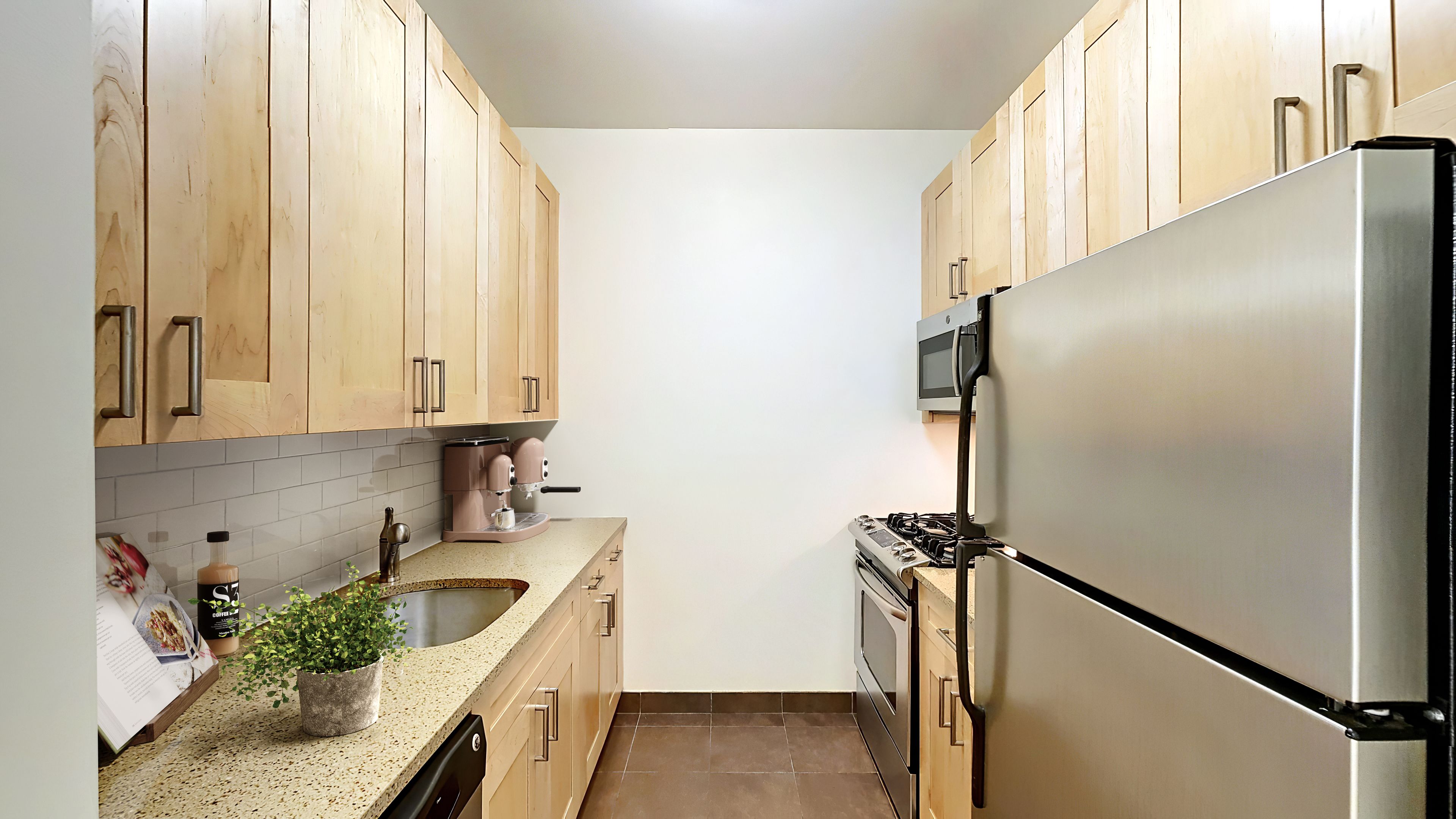 a kitchen with stainless steel appliances granite countertop a refrigerator and a sink